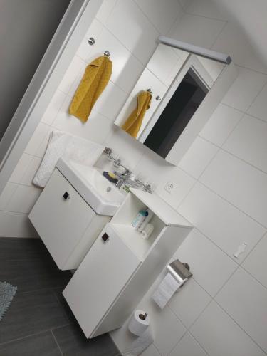 a white bathroom with a sink and a mirror at Ferienwohnung Gerti in Pinkafeld