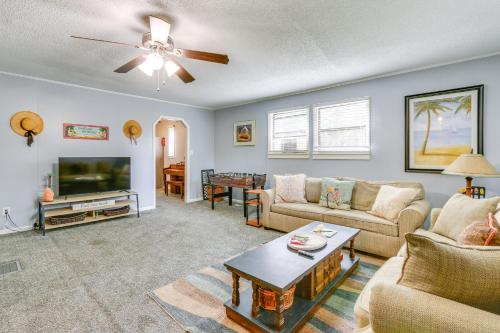 a living room with a couch and a tv at 1 Mi to Sands Beach Walkable Island Home with Yard! in Port Royal