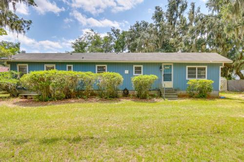 a blue house with a yard at 1 Mi to Sands Beach Walkable Island Home with Yard! in Port Royal
