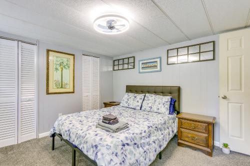 a bedroom with a bed and a nightstand with a bed sidx sidx sidx sidx at 1 Mi to Sands Beach Walkable Island Home with Yard! in Port Royal