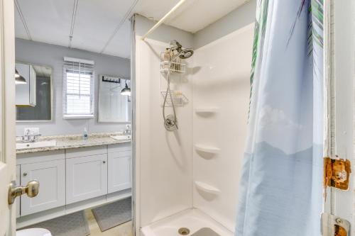 a bathroom with a shower and two sinks at 1 Mi to Sands Beach Walkable Island Home with Yard! in Port Royal