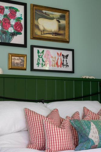 a bedroom with a bed with red and white pillows at Ivy Lodge in Rendlesham