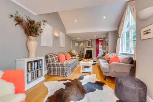a living room with two couches and a table at Ivy Lodge in Rendlesham