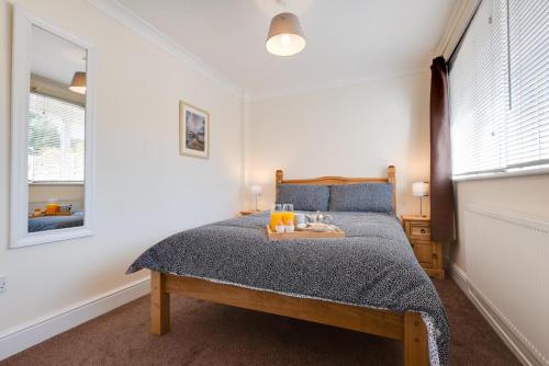 a bedroom with a bed with a tray on it at The Cart Lodge in Chedgrave