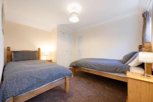 a bedroom with two beds in a room at The Cart Lodge in Chedgrave