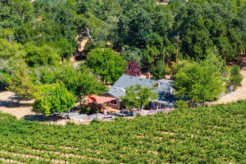 an aerial view of a house in the middle of a hill at Luxury Wine Country Haven Vineyard Views Near Top Wineries Adelaida Farmhouse in Paso Robles