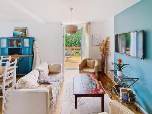 a living room with a couch and a table at Kerinou in Guimaëc