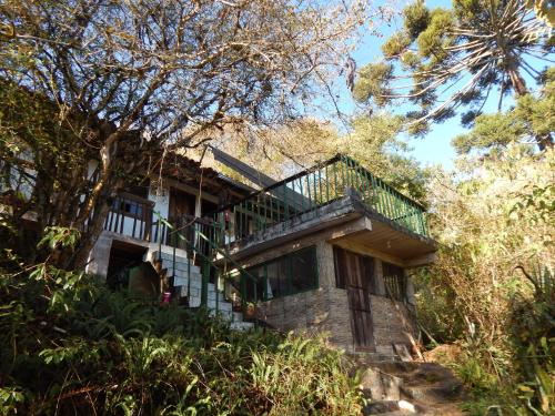 a stone house with a staircase on a hill at Suíte vista maravilhosa in Ouro Preto