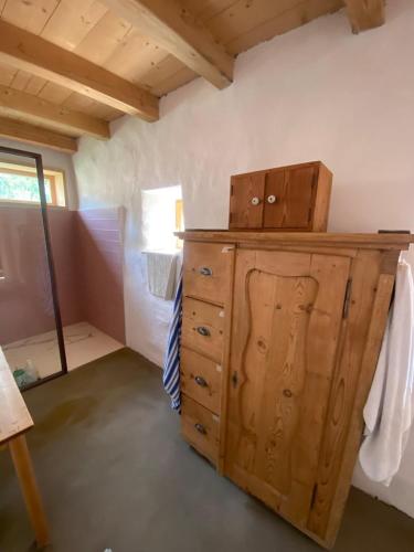 a room with a wooden dresser with boxes on it at Waldquartier Palazzo Tiefenbach in Kautzen