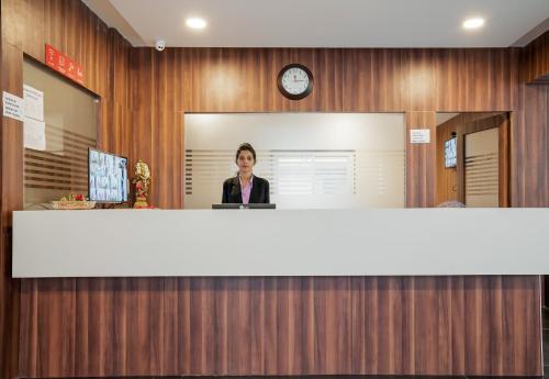 a woman standing behind a counter in an office at Super Hotel O Gokul Grand Near SR Nagar Police Station in Hyderabad