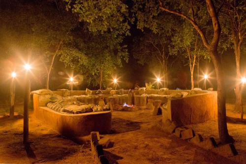 a park lit up at night with lights at Angalia Tented Camp in Mikumi