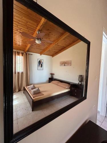 a mirror reflection of a bed in a room at Ziras Traditional Villa in Áno Váthia