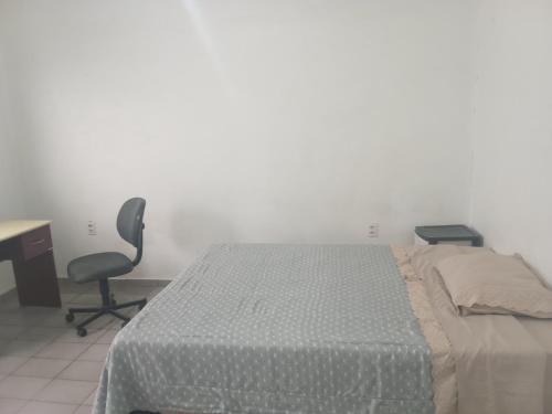 a bedroom with a bed and a desk and a chair at IncaHuasi in São Carlos