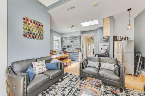 a living room with two couches and a kitchen at LIVE IT UP In The Castro! 4BRWDWalk Score 98 in San Francisco