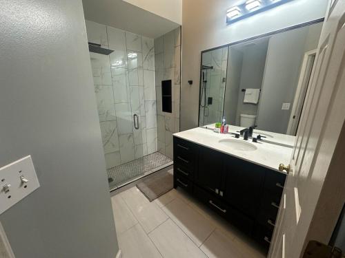 a bathroom with a sink and a large mirror at Cozy Stay Springfield Townhome in Springfield