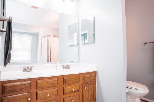 a bathroom with a sink and a mirror at Cozy Stay Springfield Townhome in Springfield