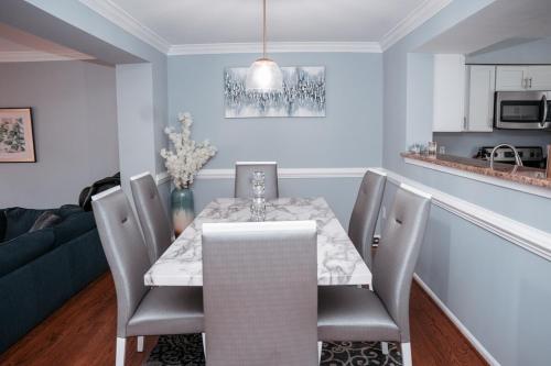 a dining room with a white table and chairs at Cozy Stay Springfield Townhome in Springfield