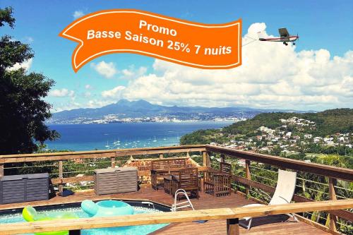 a sign for a house with a swimming pool on a balcony at Spot idéal en Famille ou Amis - Piscine, Vue Mer et Calme - Anse à l'Âne in Les Trois-Îlets