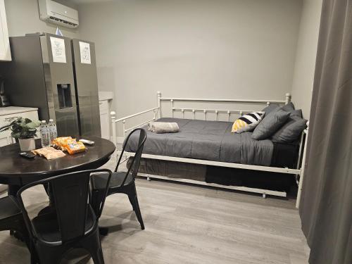 a bedroom with a bed and a table with chairs at Gorgeous House & Loft Near Downtown in San Antonio