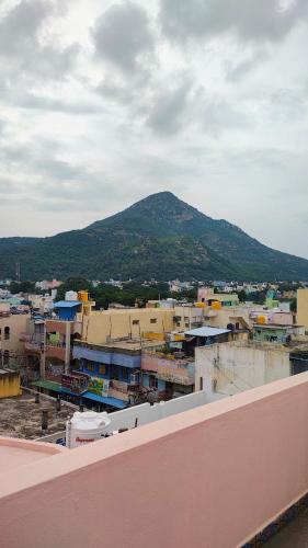 a view of a city with a mountain in the background at RHS rooms in Tiruvannāmalai