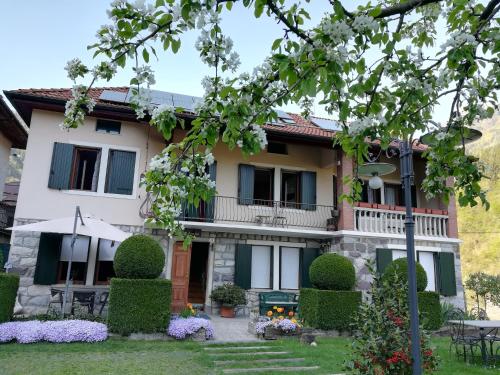 a house with a garden in front of it at B&B OLTRA in Lamon