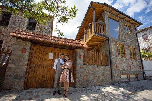 a man and a woman standing in front of a building at Villa Old House BN in Bitola
