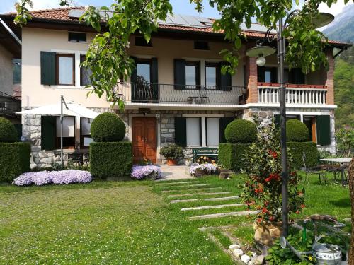a house with a garden in front of it at B&B OLTRA in Lamon