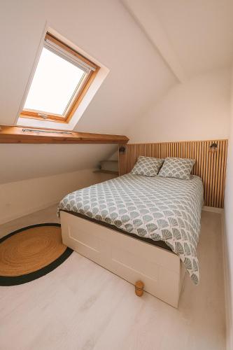 a bedroom with a bed and a window at Cosy Garden DisneyLand in Quincy-Voisins