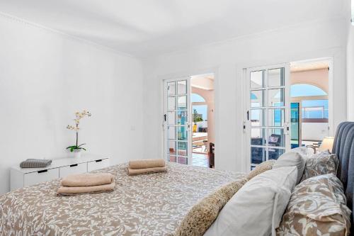 a white bedroom with a bed with two pillows on it at Villa Venezuela by Villa Plus in Callao Salvaje