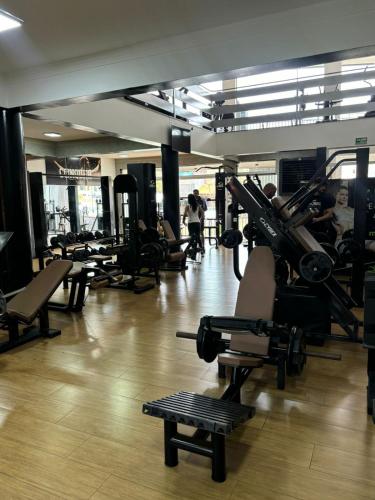 a gym with a bunch of treadmills and chairs at Hotel Dan Inn Franca & Convenções By Nacional Inn in Franca