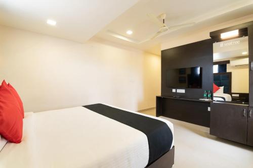 a hotel room with a bed and a kitchen at Capital O Seatree in Visakhapatnam