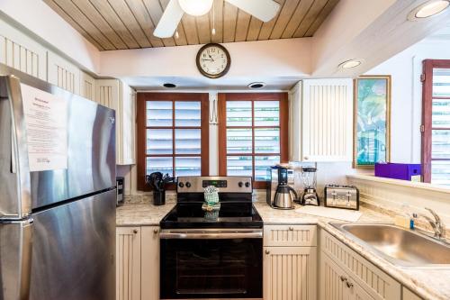 a kitchen with a stainless steel refrigerator and a sink at Hemingway's View in Key West