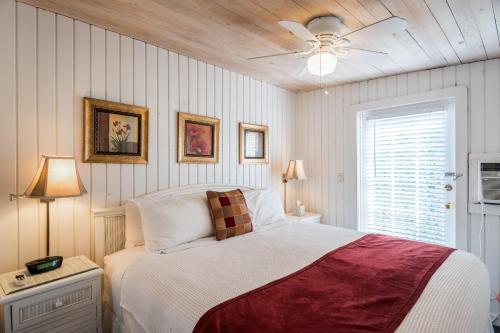 a bedroom with a bed and a ceiling fan at Hemingway's View in Key West