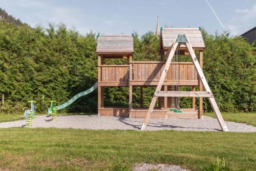 a playground with a ladder and a slide at Appartement Pension Strolz in Bichlbach