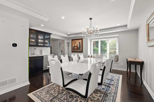 a dining room with a white table and chairs at The Gahanna Grand in Columbus