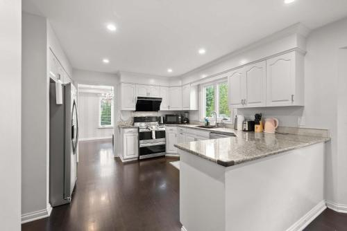 a kitchen with white cabinets and a counter top at The Gahanna Grand in Columbus