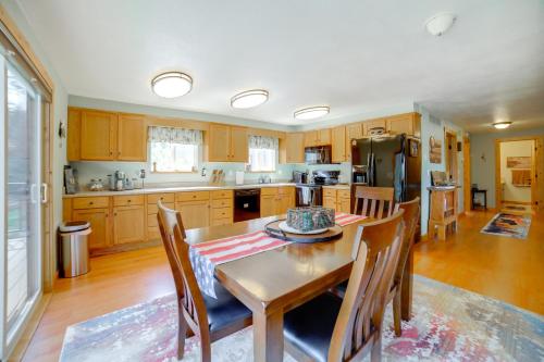 a kitchen with a table and chairs and a refrigerator at Mtn-View Oasis with Pool Access in Garden Valley in Garden Valley