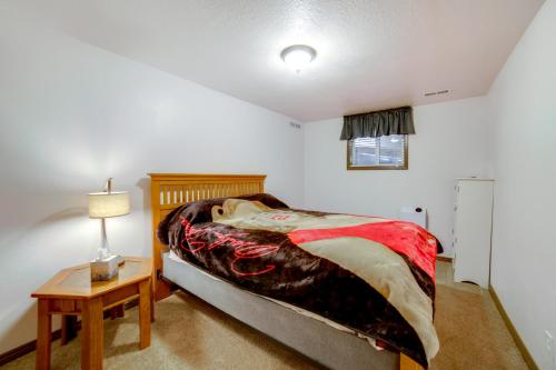 a bedroom with a bed and a table with a lamp at Mtn-View Oasis with Pool Access in Garden Valley in Garden Valley