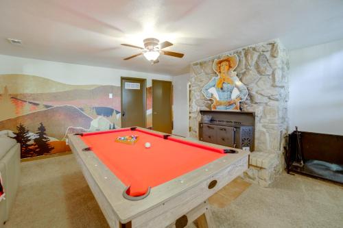 a room with a pool table in front of a stone wall at Mtn-View Oasis with Pool Access in Garden Valley in Garden Valley