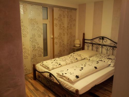 a bedroom with a bed with a wrought iron frame at Villa Mondry in Bad Pyrmont