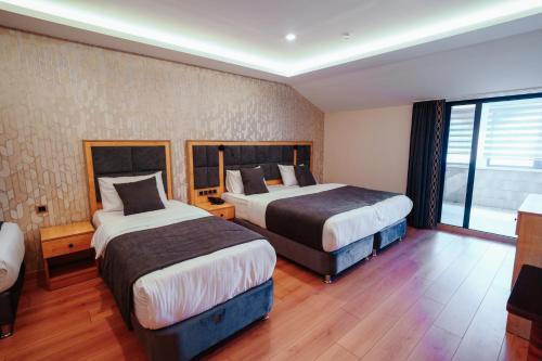 Ένα ή περισσότερα κρεβάτια σε δωμάτιο στο Hotel Yaman