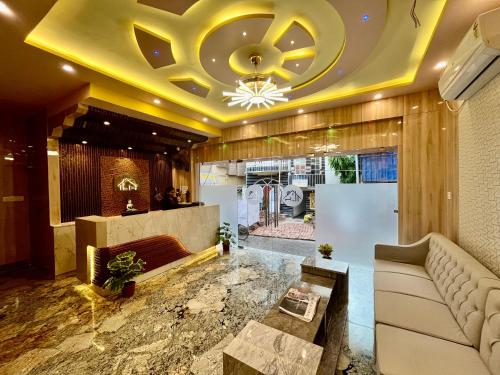 a lobby with a couch and a ceiling at The Little Heaven Hotel near Kolkata Airport in kolkata