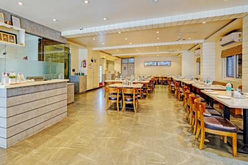 a dining room with tables and chairs in a restaurant at Super Townhouse OAK Clove Boutique Hotel Rajaji Nagar Near Lulu Mall Bengaluru in Bengaluru