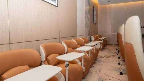 a row of tables and chairs in a waiting room at فندق روزا جراند غرناطه in Riyadh