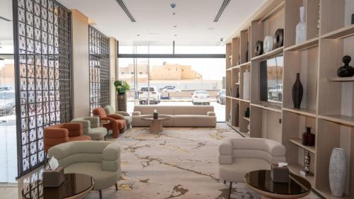 a lobby with couches and tables in a building at فندق روزا جراند غرناطه in Riyadh