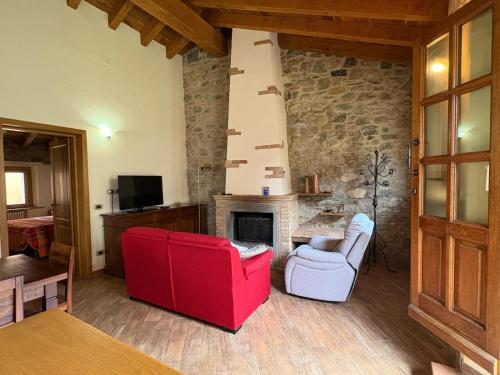 a living room with two chairs and a fireplace at La casa di Bianca b&b in Collagna