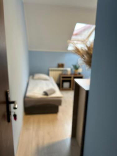 a room with a bed in a room with a door at Karczma gę gę gę Pokoje in Połajewo