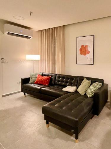 a black leather couch in a living room at 3BR Gem Steps from Shuk Machne Yehuda in Jerusalem