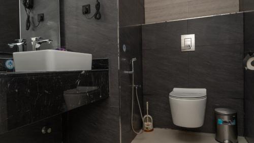 a bathroom with a sink and a toilet at Rosa Grand Hotel in Riyadh