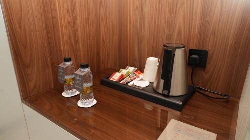 a counter with a coffee maker and a coffeemaker at Rosa Grand Hotel in Riyadh